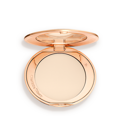 An open, pressed powder compact in a cream colour. 