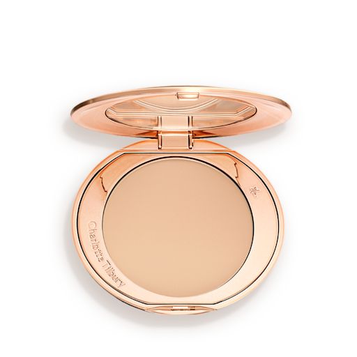 An open, pressed powder compact in a light beige shade. 