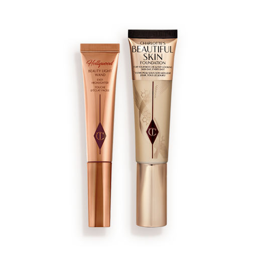 Highlighter wand in light gold-coloured packaging with a foundation wand in gold packaging with a ashy brown-beige-coloured body to show the shade of the foundation inside, and a gold-coloured lid.