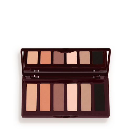 An open, mirrored-lid six-pan eyeshadow palette with matte eyeshadows in brown, peach, and beige shades.